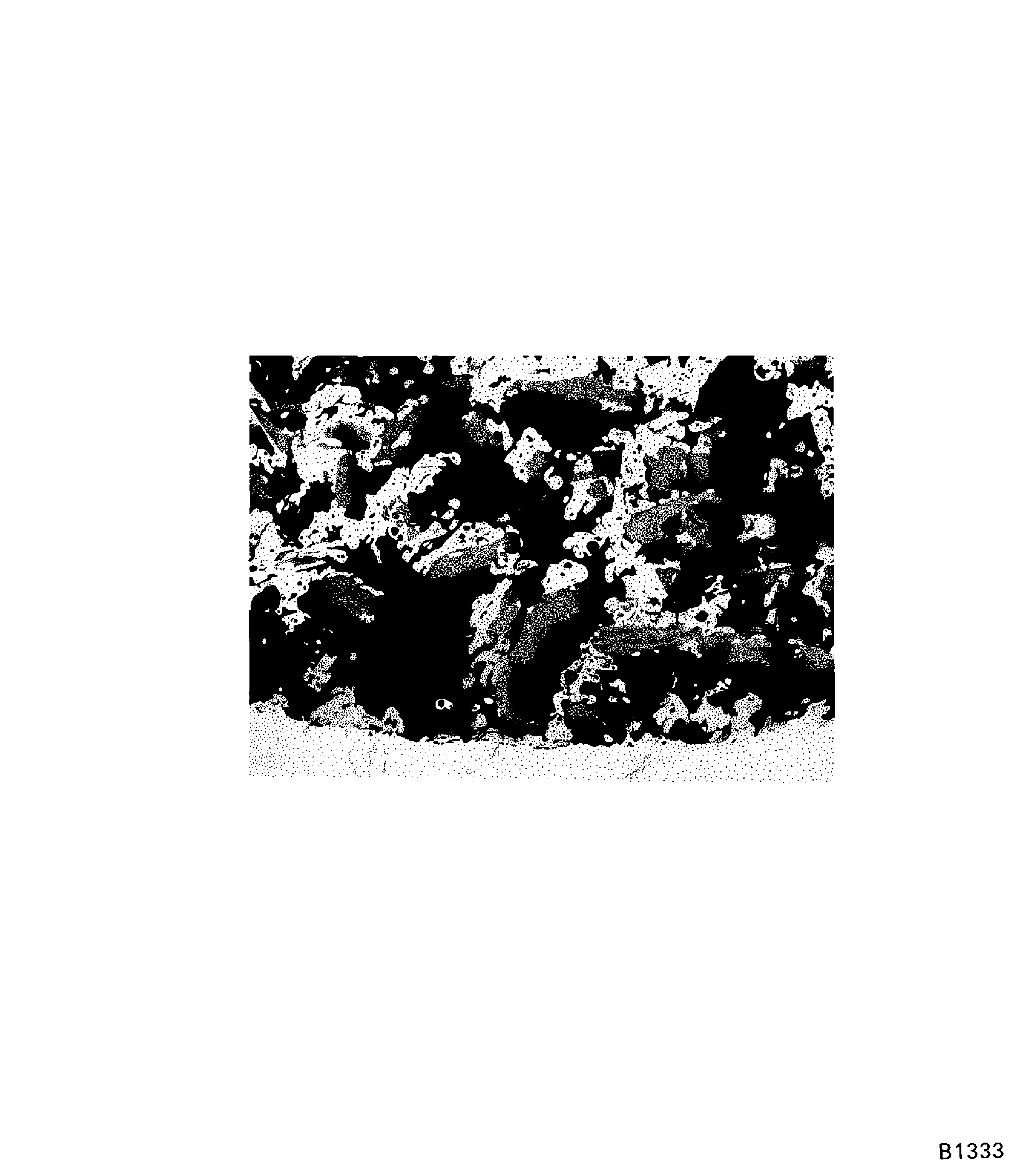 Unsatisfactory porosity in PWA 75-1 coating on blade roots (100X)